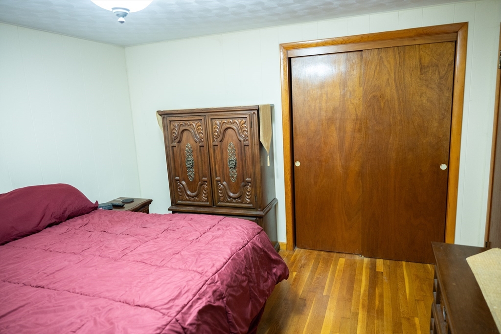 10 Chris Road Oxford, MA 01540 - Photo 19 of 42 a bedroom with a bed and a mirror