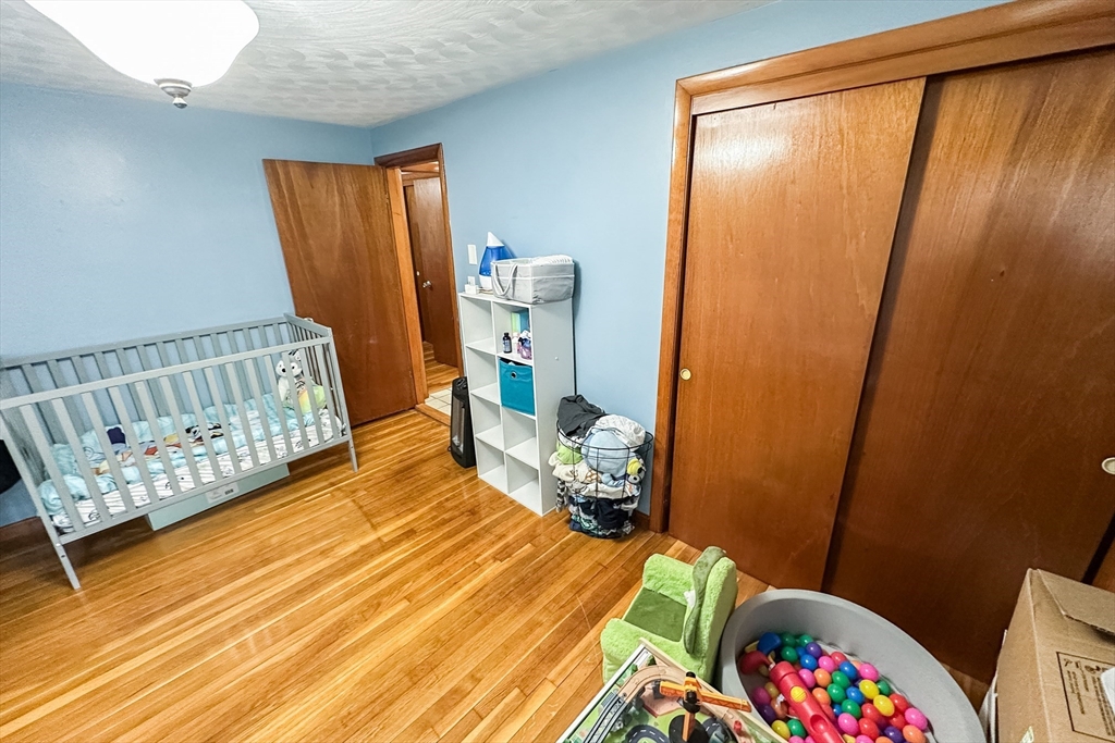 10 Chris Road Oxford, MA 01540 - Photo 23 of 42 a bedroom with a bed and wooden floor