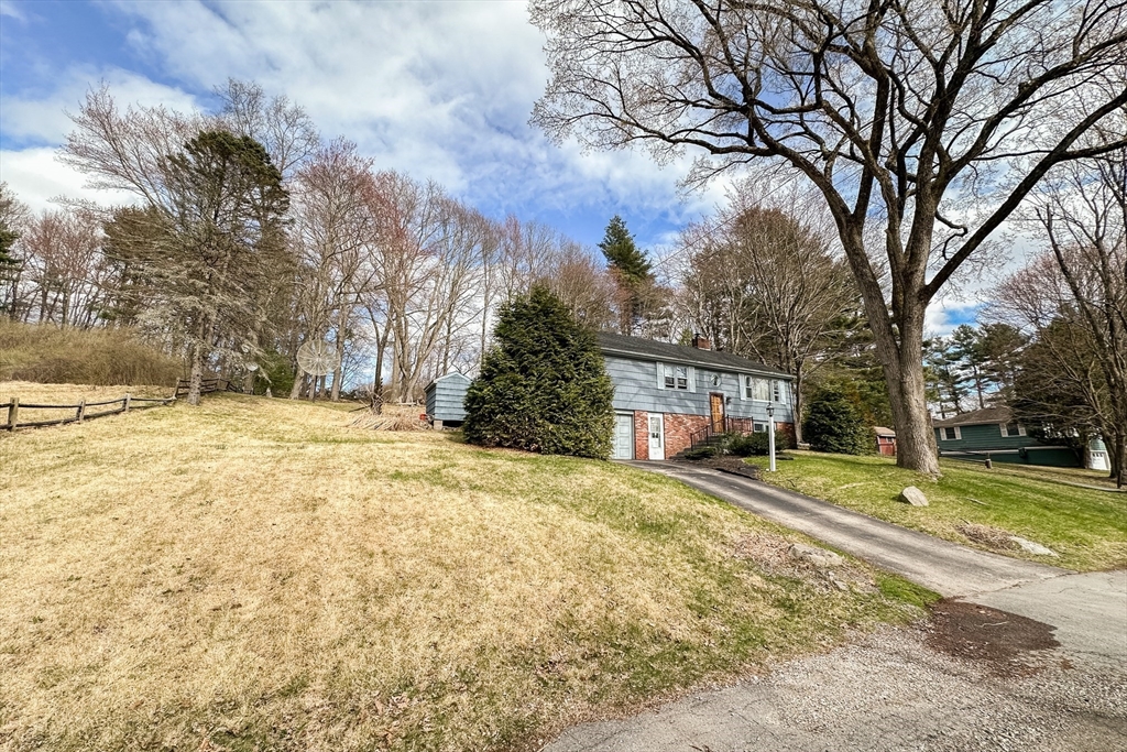 10 Chris Road Oxford, MA 01540 - Photo 39 of 42 a yellow house with trees in front of it