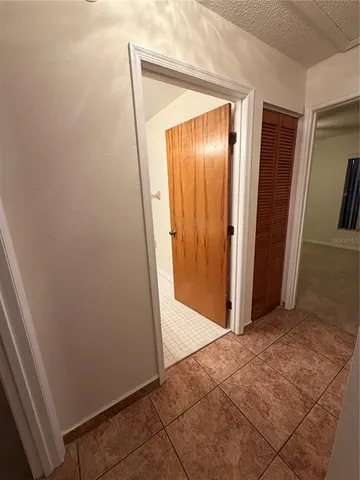 an empty room with a ceiling fan and a window