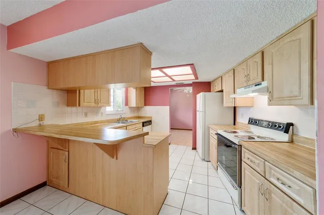 a view of a kitchen with a sink and a window