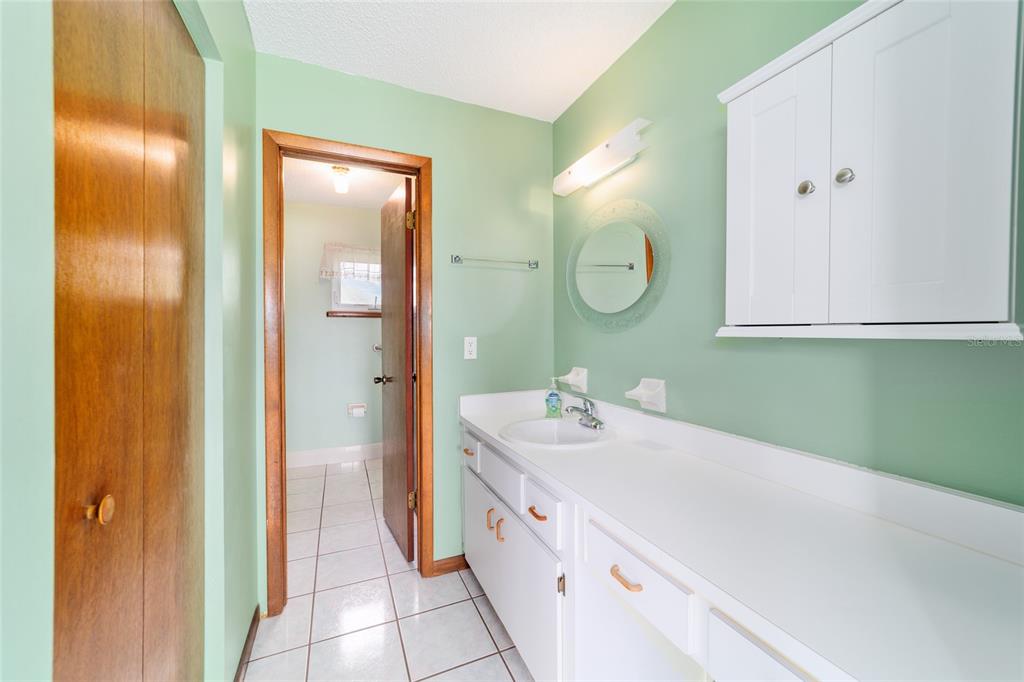 9841 Southwest 102nd Place Ocala, FL 34481 - Photo 39 of 66 a spacious bathroom with a double vanity sink mirror and