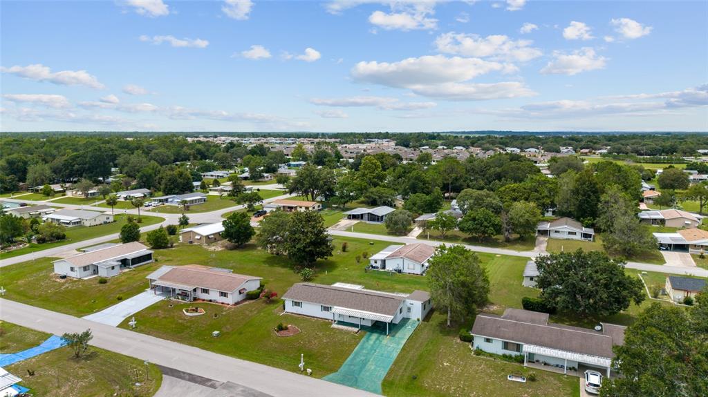 9841 Southwest 102nd Place Ocala, FL 34481 - Photo 66 of 66 an aerial view of a city with lots of residential buildings ocean and mountain view in back