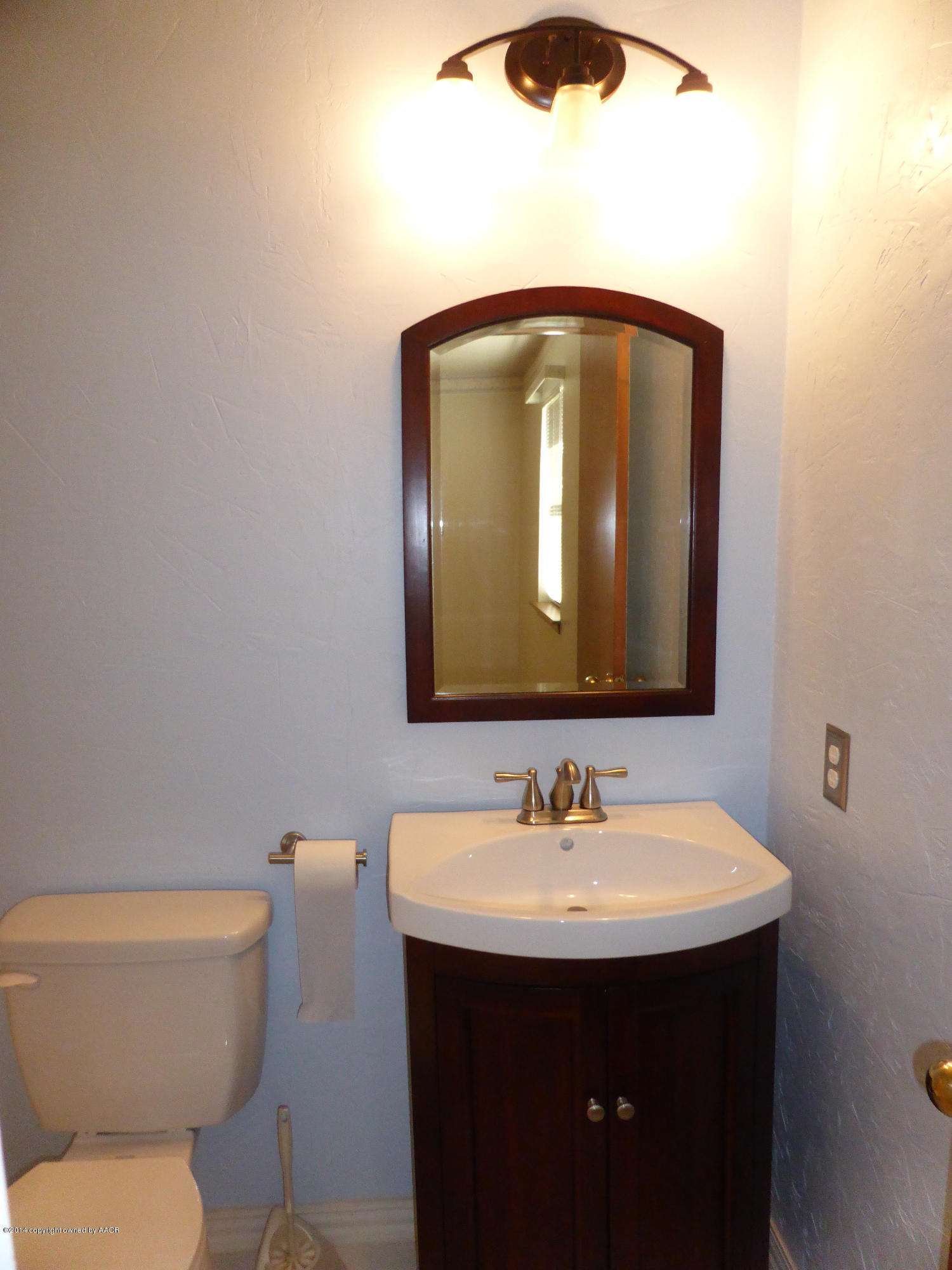8112 Marni Trail Amarillo, TX 79110 - Photo 12 of 22 a bathroom with a toilet sink and mirror