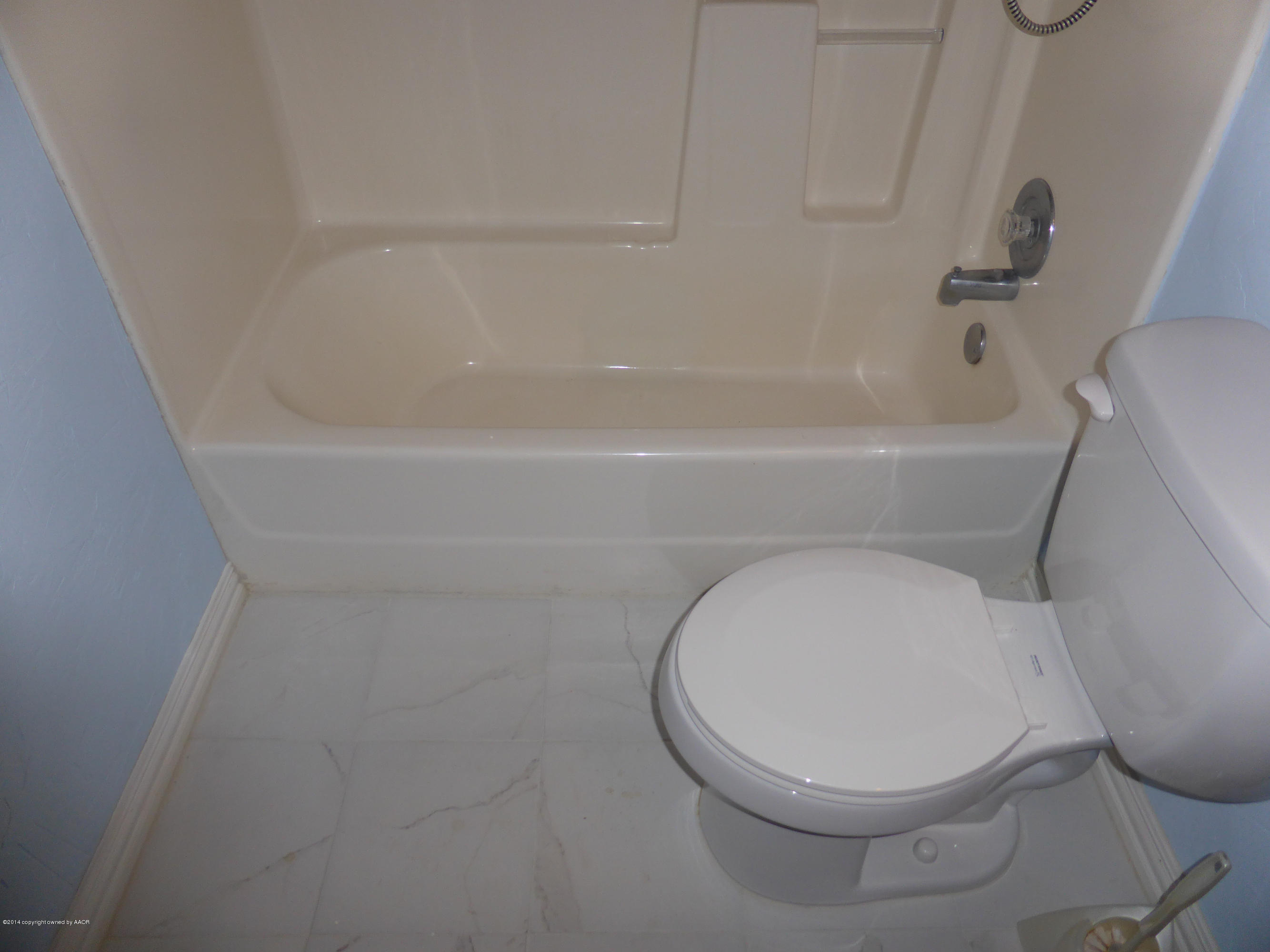 8112 Marni Trail Amarillo, TX 79110 - Photo 13 of 22 a white toilet sitting next to a bath tub