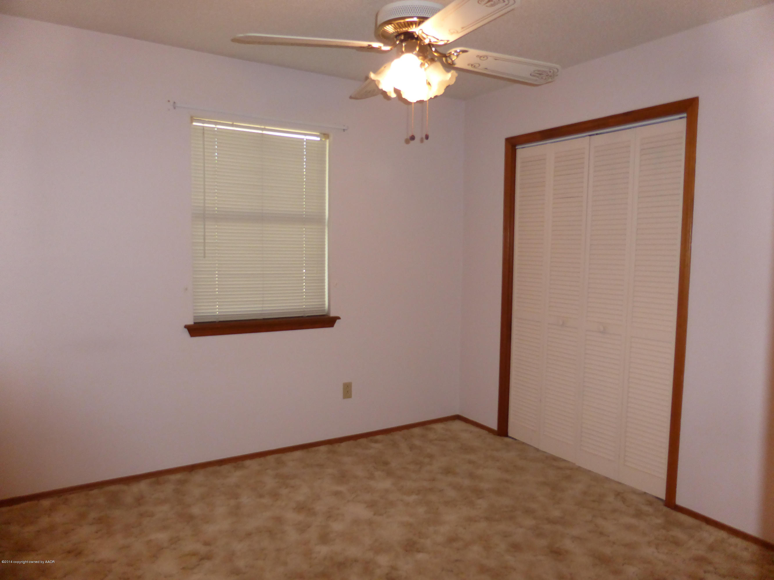 8112 Marni Trail Amarillo, TX 79110 - Photo 14 of 22 an empty room with a window and a fan