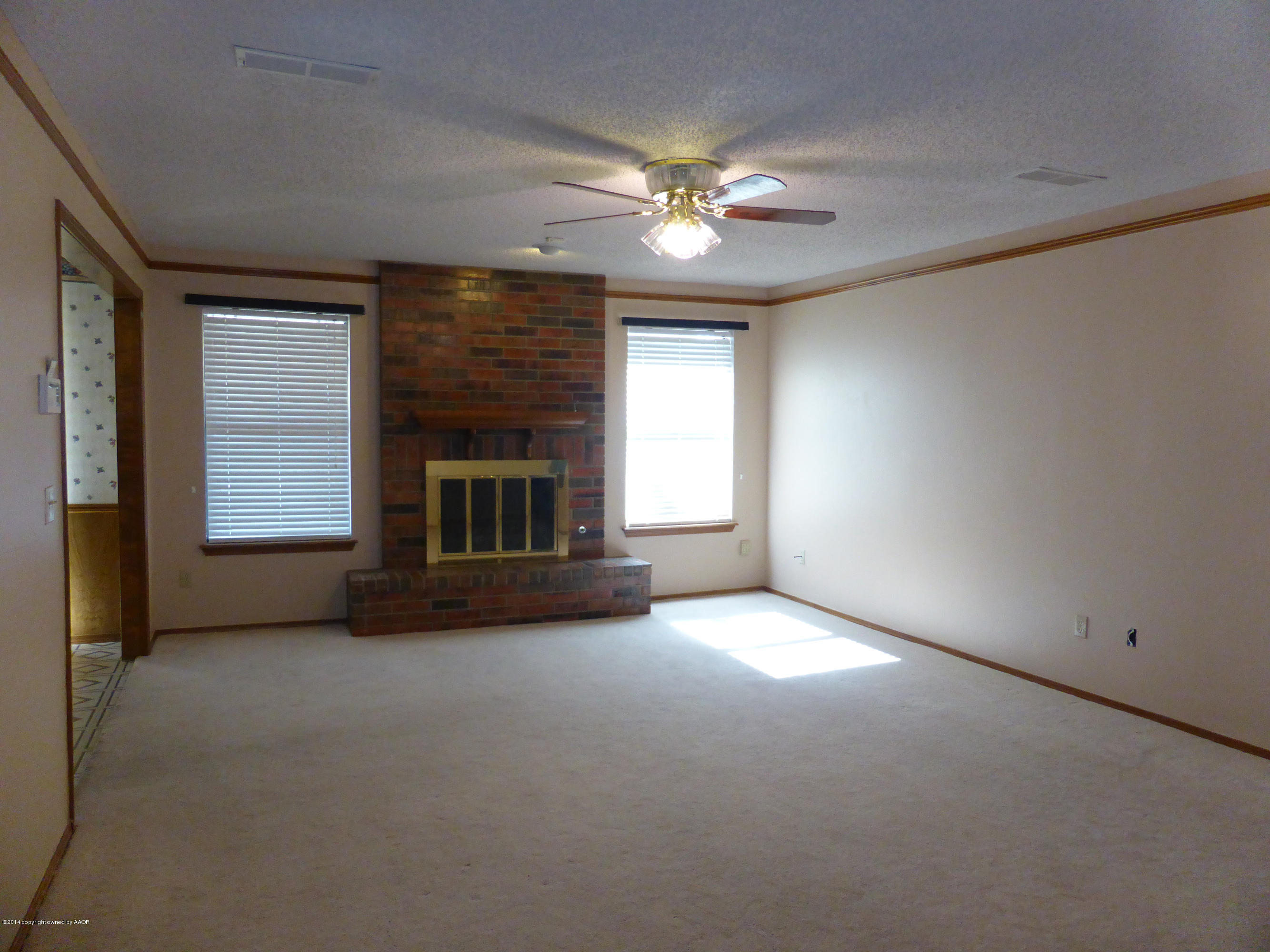 8112 Marni Trail Amarillo, TX 79110 - Photo 3 of 22 a view of a livingroom with a fireplace and window