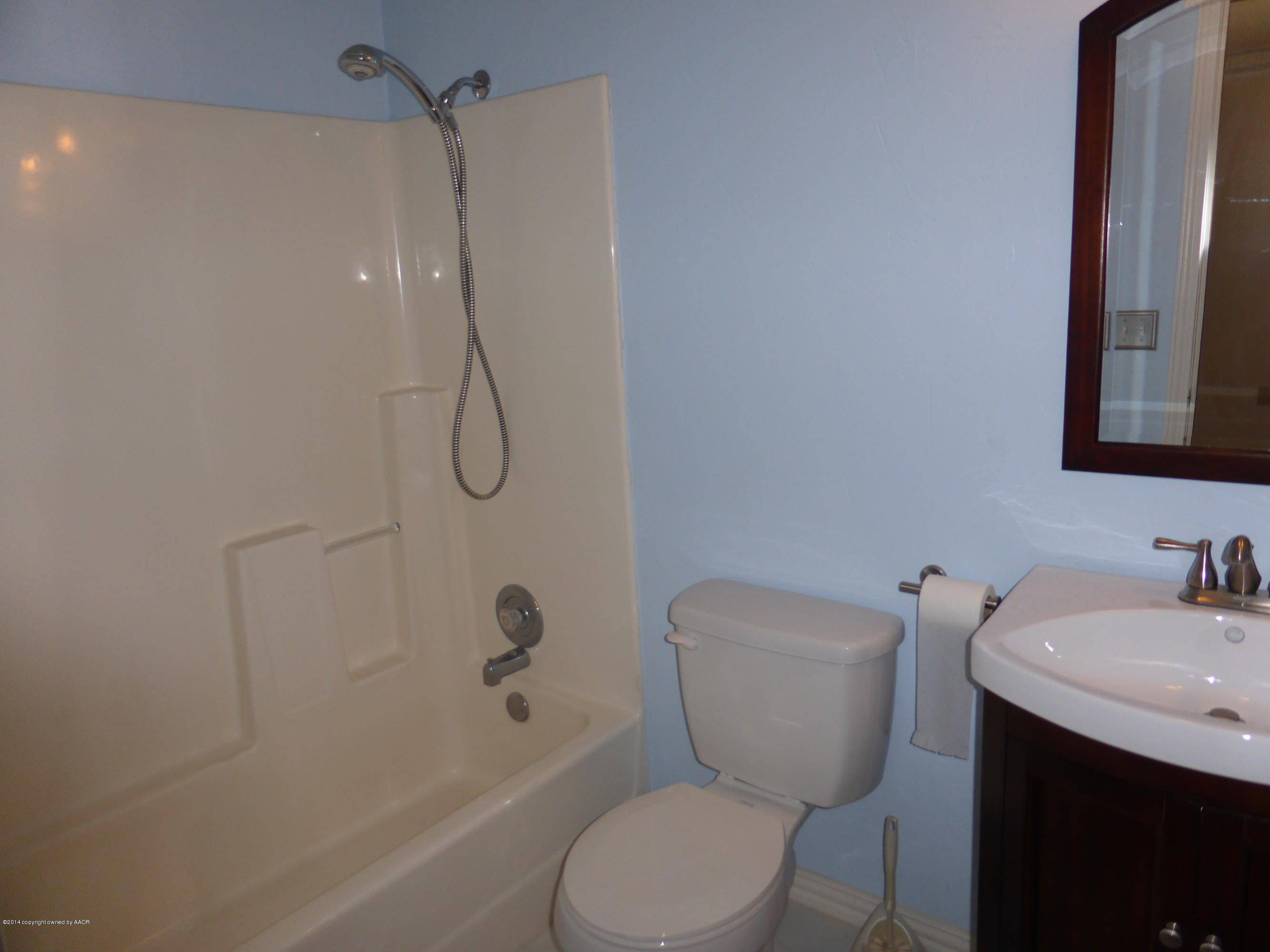 8112 Marni Trail Amarillo, TX 79110 - Photo 10 of 22 a bathroom with a toilet sink shower and mirror