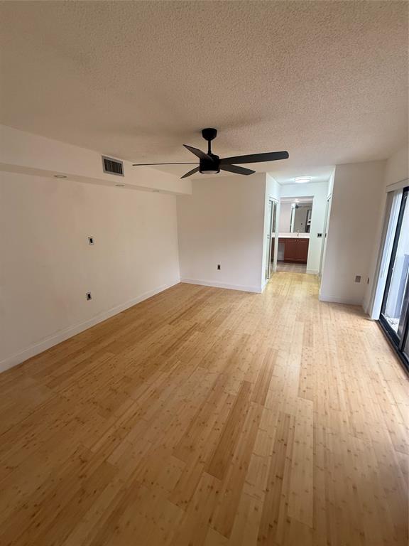 9138 Southwest 23rd Street, Unit B Davie, FL 33324 - Photo 11 of 21 wooden floor in an empty room with a window
