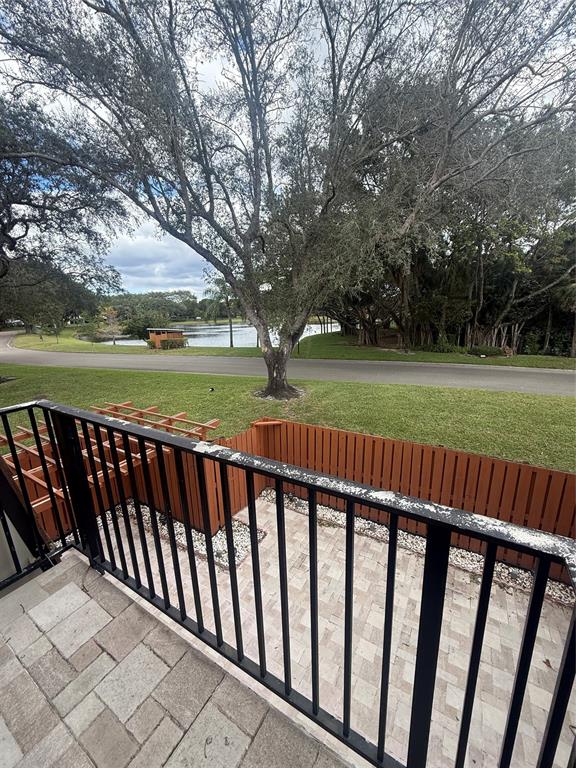 9138 Southwest 23rd Street, Unit B Davie, FL 33324 - Photo 12 of 21 a view of deck and yard with large trees
