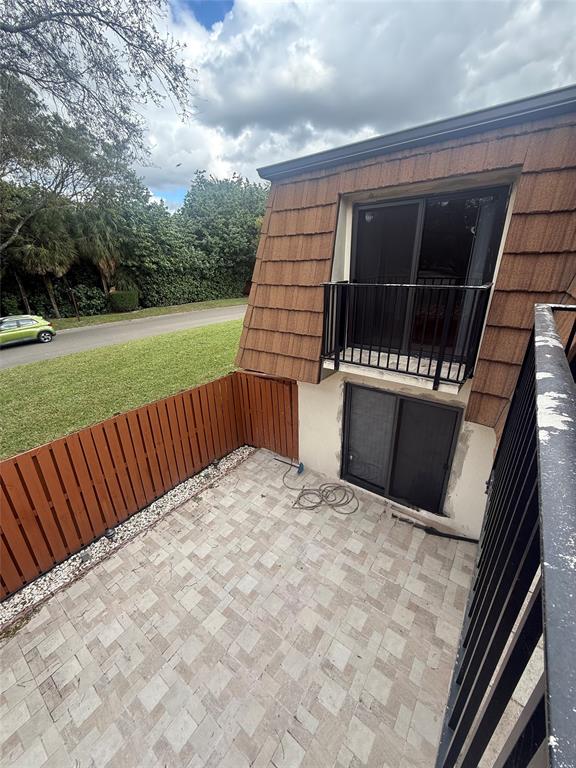 9138 Southwest 23rd Street, Unit B Davie, FL 33324 - Photo 14 of 21 a view of balcony with wooden floor and fence