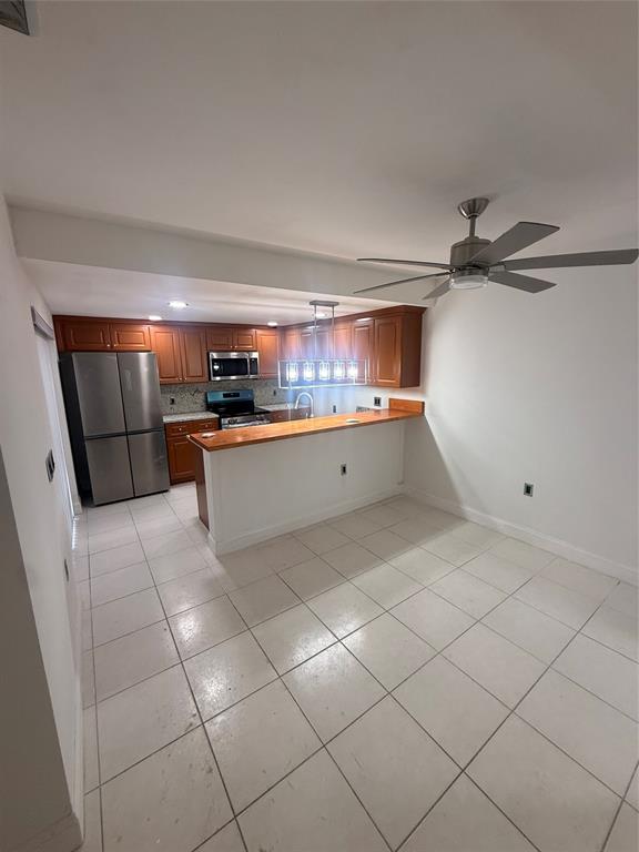9138 Southwest 23rd Street, Unit B Davie, FL 33324 - Photo 4 of 21 a kitchen with stainless steel appliances a refrigerator and a sink