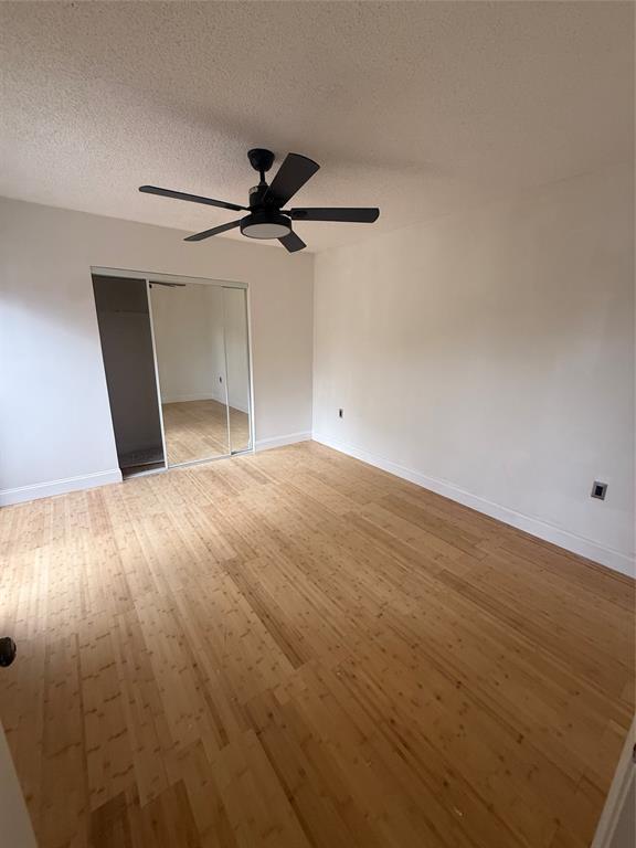 9138 Southwest 23rd Street, Unit B Davie, FL 33324 - Photo 10 of 21 an empty room with wooden floor closet and windows