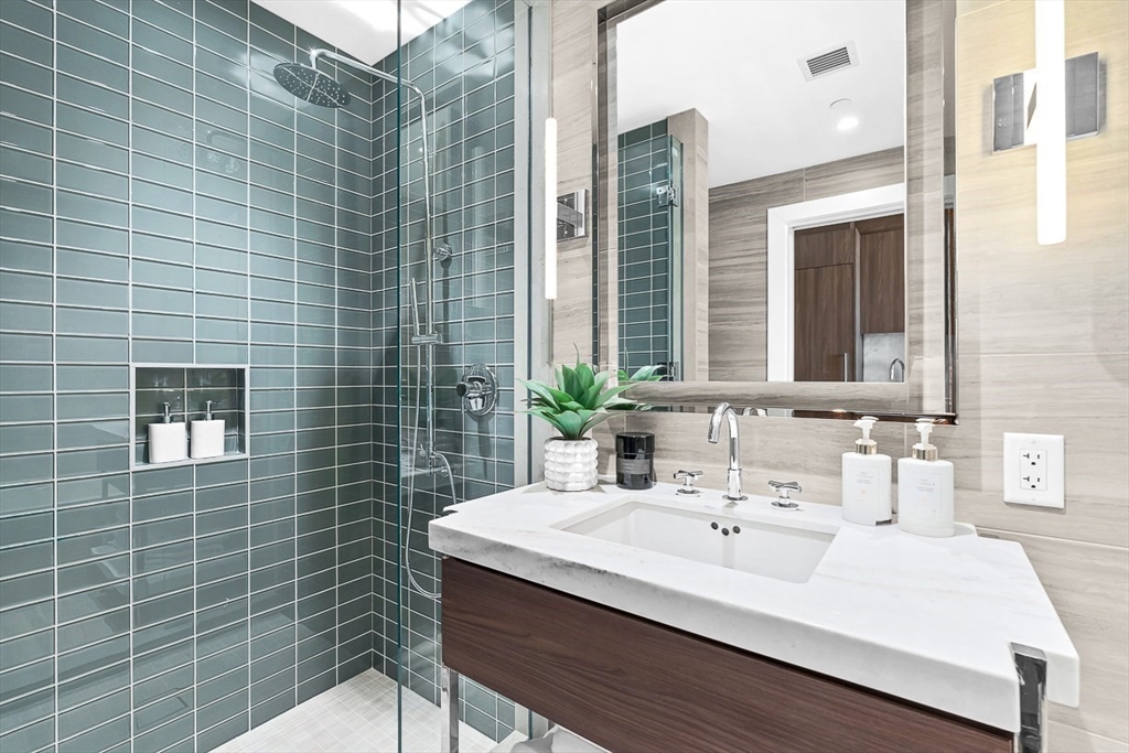 40 Trinity Place, Unit 1604 Boston, MA 02116 - Photo 14 of 38 a bathroom with a sink and a mirror