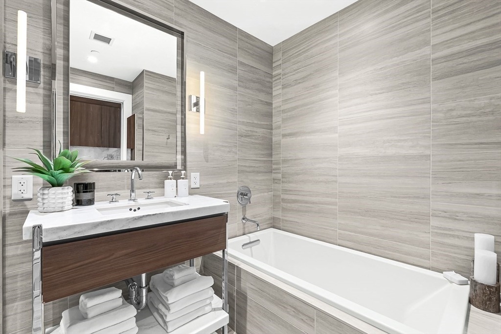 40 Trinity Place, Unit 1604 Boston, MA 02116 - Photo 15 of 38 a white bath tub sitting next to a white sink