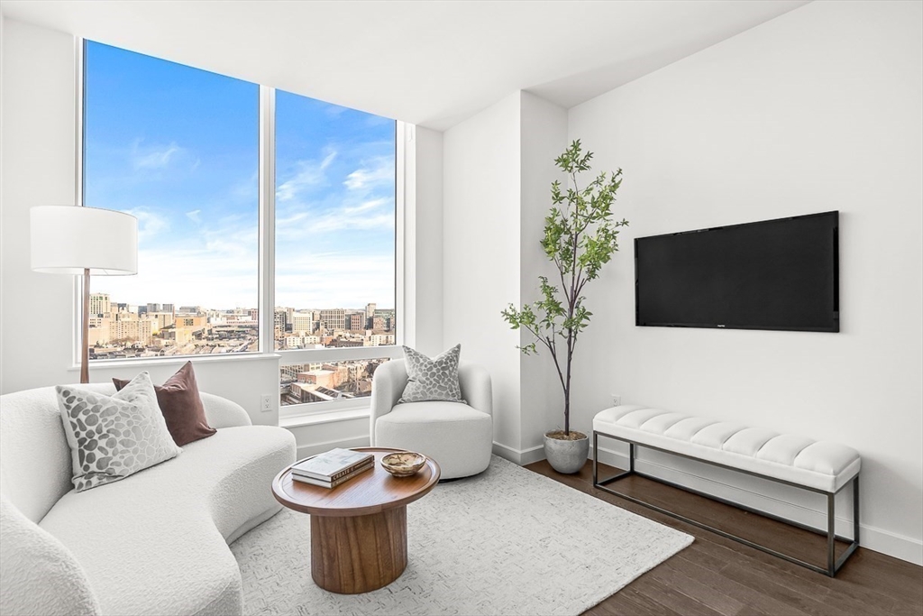 40 Trinity Place, Unit 1604 Boston, MA 02116 - Photo 2 of 38 a living room with furniture and a flat screen tv