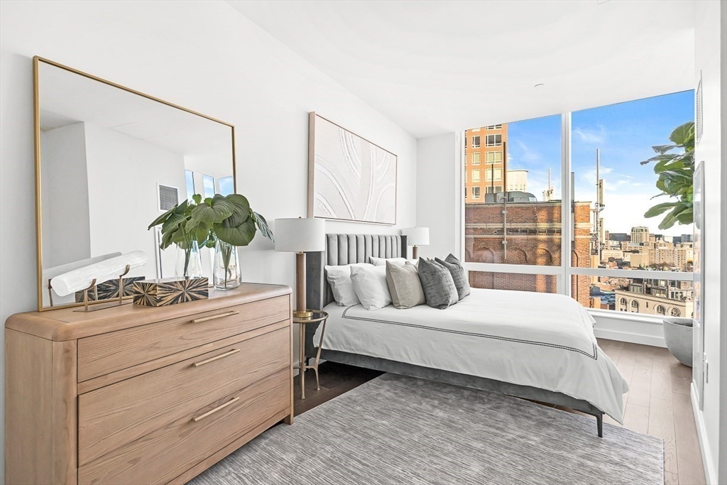 40 Trinity Place, Unit 1604 Boston, MA 02116 - Photo 3 of 38 a bedroom with a large bed and a large window