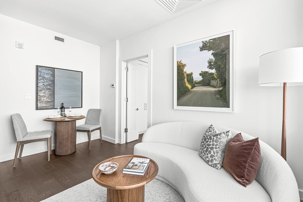 40 Trinity Place, Unit 1604 Boston, MA 02116 - Photo 8 of 38 a living room with furniture a rug and a painting on the wall