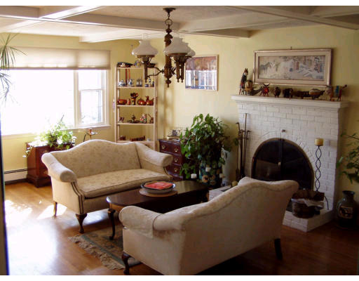 8 Angela Street Canton, MA 02021 - Photo 3 of 5 a living room with furniture large window and a fireplace