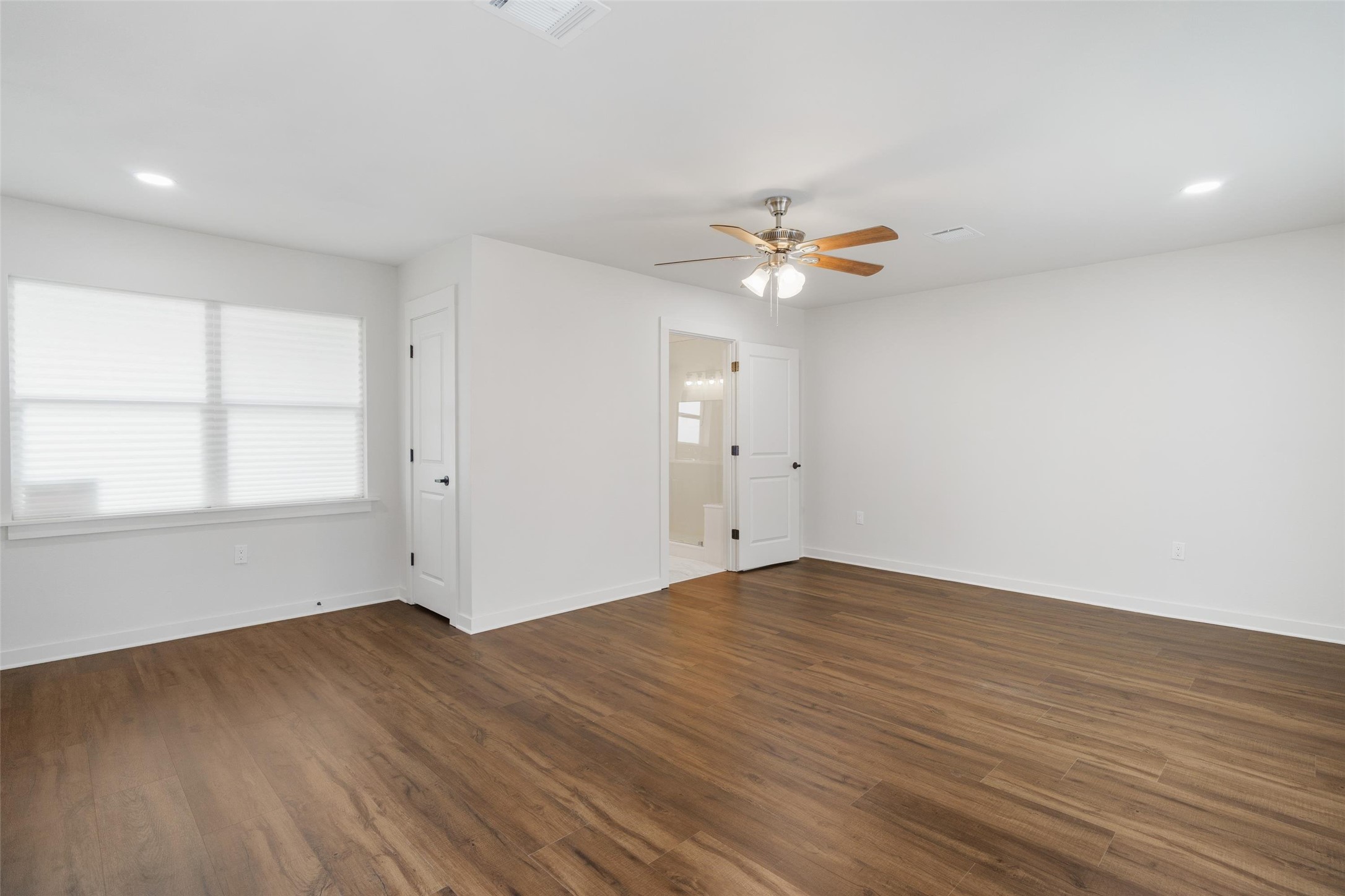1801 Harding Street Pasadena, TX 77502 - Photo 14 of 22 an empty room with wooden floor and a ceiling fan