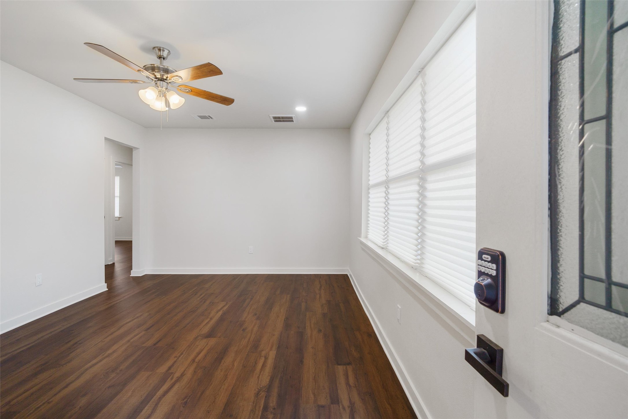 1801 Harding Street Pasadena, TX 77502 - Photo 5 of 22 a view of an empty room with a window and wooden floor