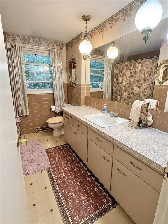 16 Meadowview Road Holyoke, MA 01040 - Photo 11 of 22 a spacious bathroom with a double vanity sink a mirror a bathtub and next to a window