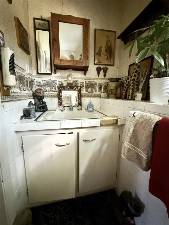 16 Meadowview Road Holyoke, MA 01040 - Photo 17 of 22 a bathroom with a sink and a mirror