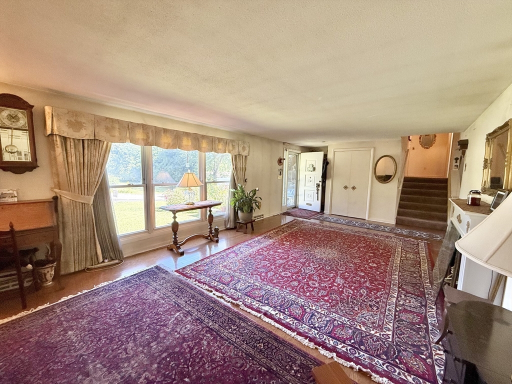 16 Meadowview Road Holyoke, MA 01040 - Photo 3 of 22 a living room with furniture a rug and a flat screen tv