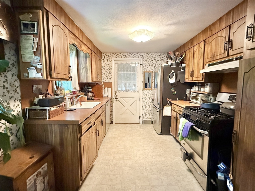 16 Meadowview Road Holyoke, MA 01040 - Photo 7 of 22 a kitchen with stainless steel appliances a stove a sink and a refrigerator