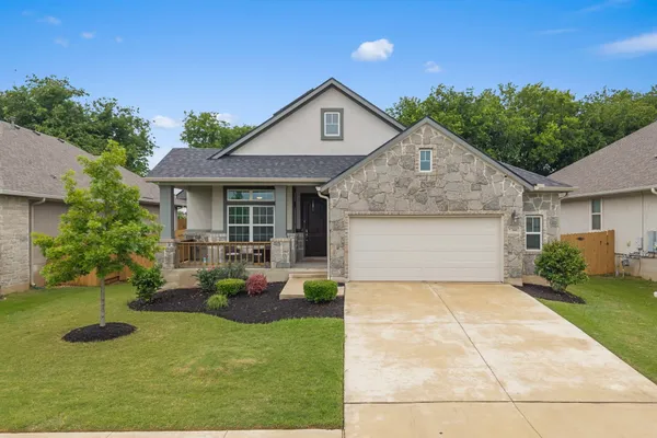 a front view of house with yard and green space
