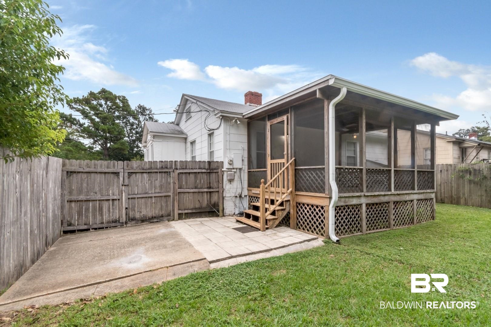 208 Morgan Avenue Mobile, AL 36606 - Photo 23 of 27 Back of property with a sunroom, a patio area, and a yard