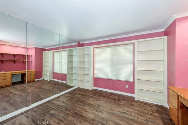 a view of a room with wooden floor and windows
