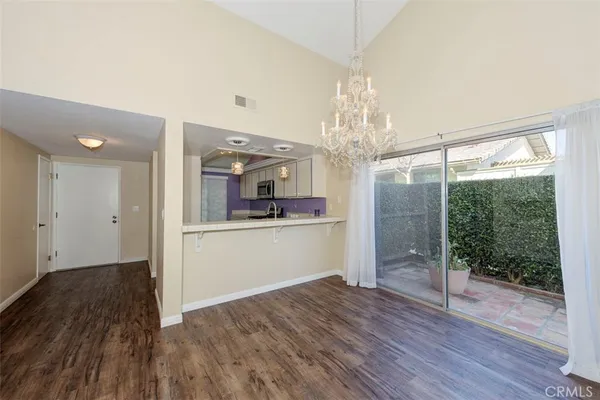 a view of a kitchen with wooden floor and a kitchen