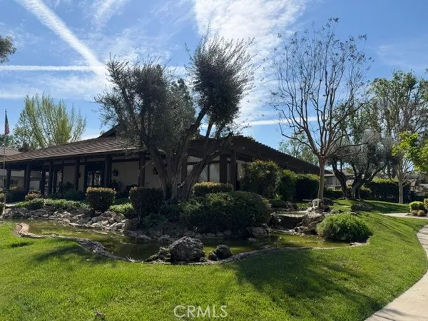 a view of backyard of house with green space