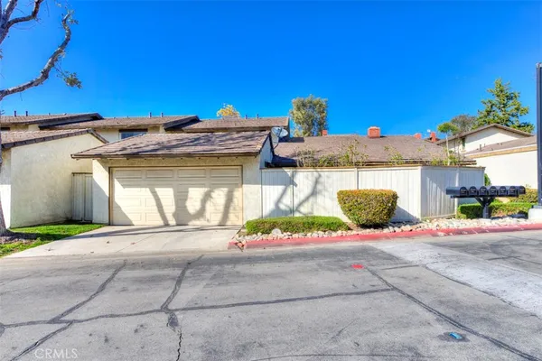 a view of a house with a yard and garage