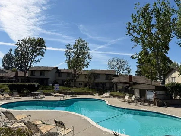 a view of a house with swimming pool and sitting area