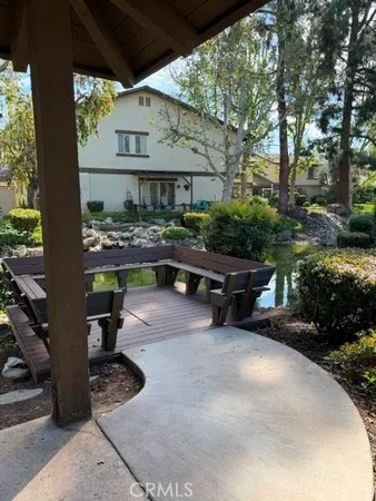 a view of backyard with outdoor seating and plants