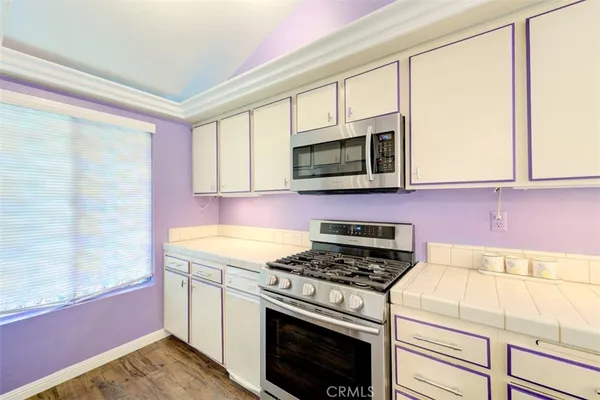 a kitchen with a stove microwave and sink