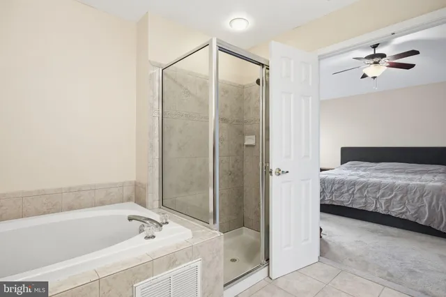 a bathroom with a tub a sink and mirrors