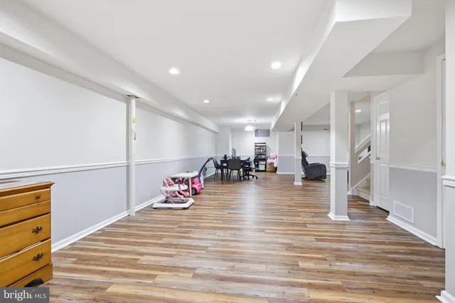 a view of a room with wooden floor