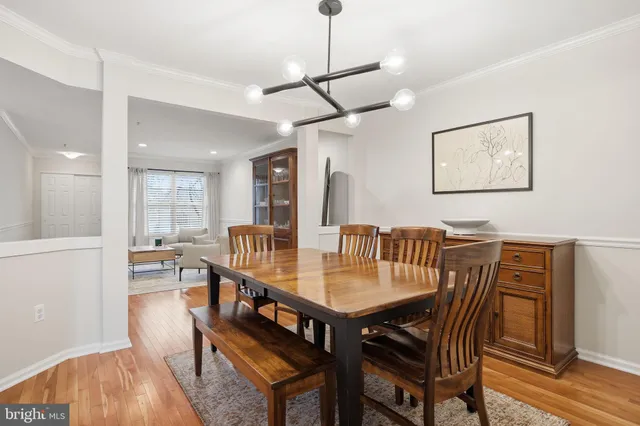 a view of a a dining room with furniture window and wooden floor