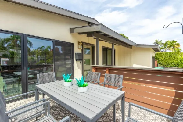 a view of the patio with couches and a table and chairs