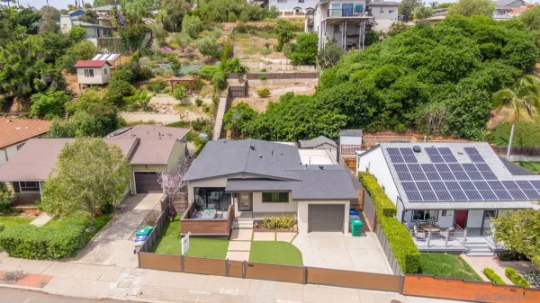an aerial view of a house with a yard
