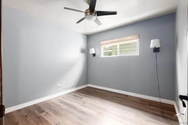 a bedroom with a bed and a night stand