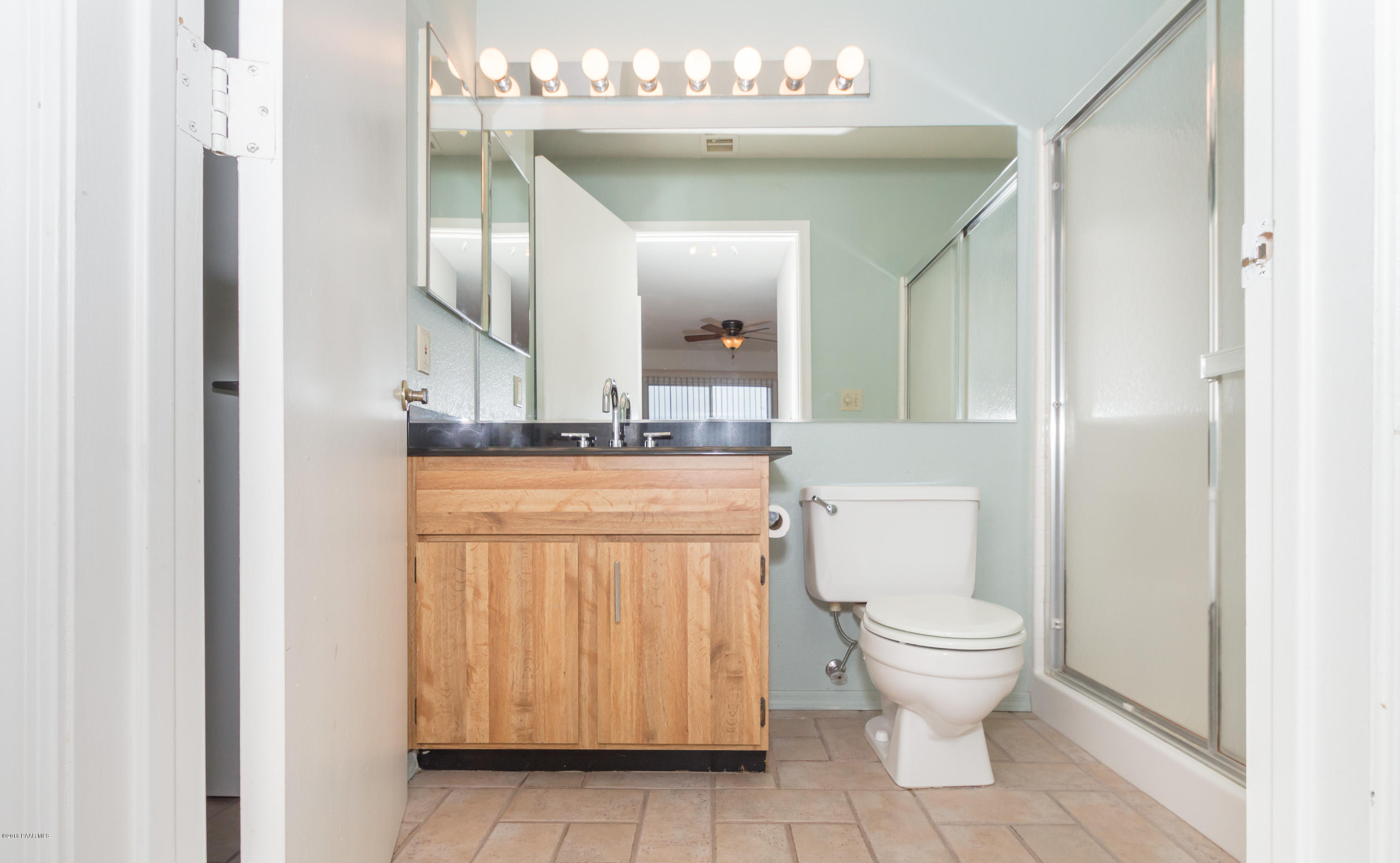 3059 Smokey Road, Unit 21B Prescott, AZ 86301 - Photo 12 of 21 a bathroom with a toilet a sink and mirror