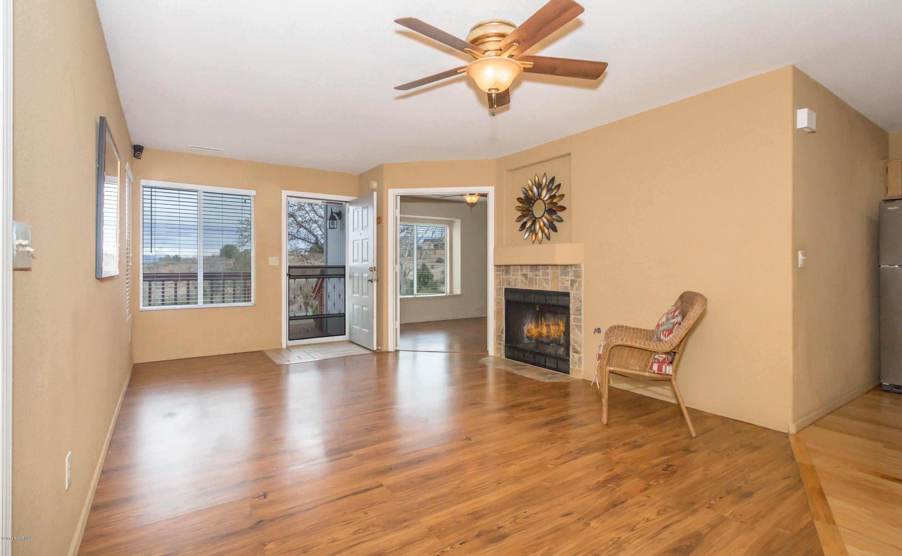 3059 Smokey Road, Unit 21B Prescott, AZ 86301 - Photo 2 of 21 a view of an empty room with a window and wooden floor