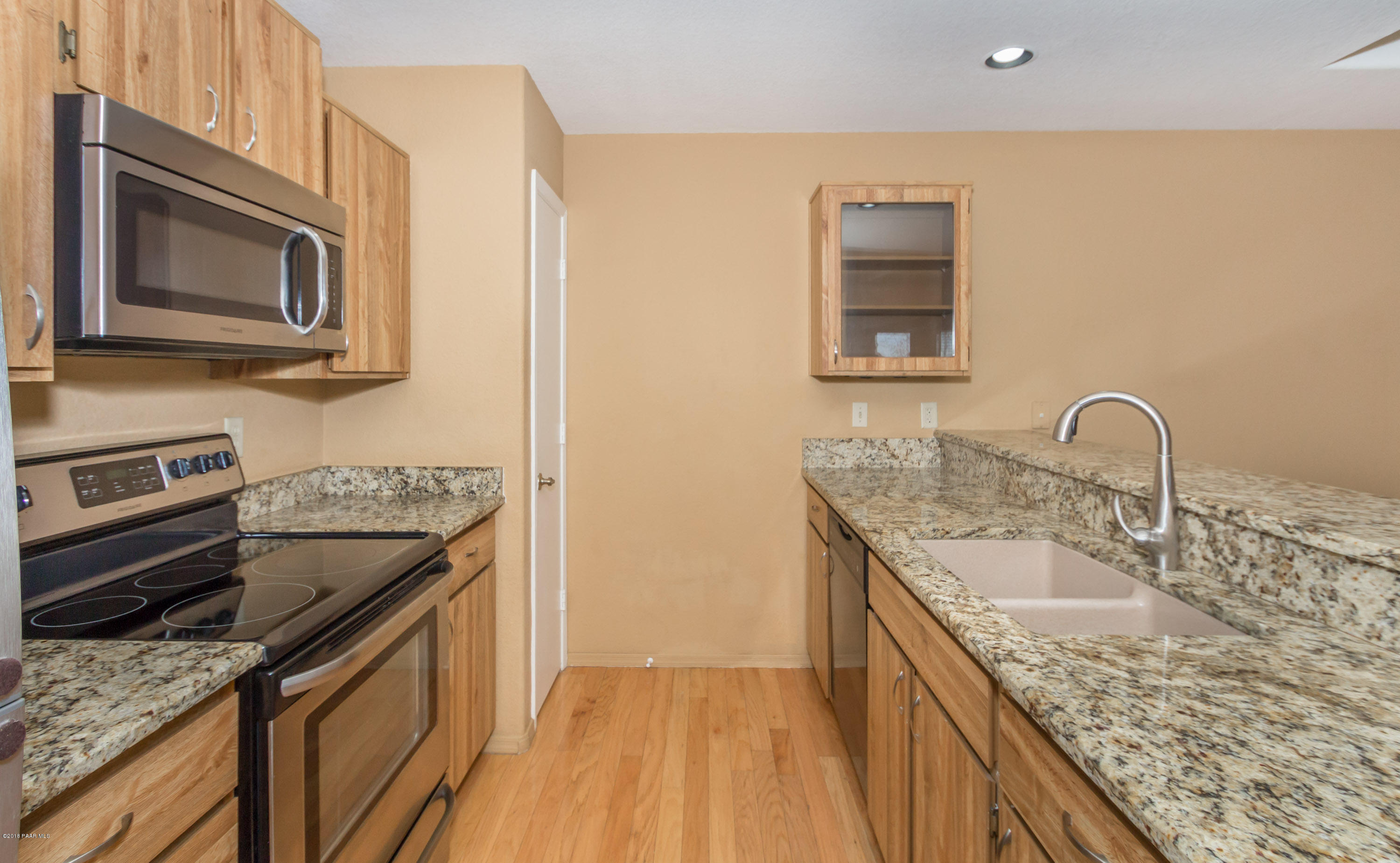3059 Smokey Road, Unit 21B Prescott, AZ 86301 - Photo 5 of 21 a kitchen with a sink stove and microwave