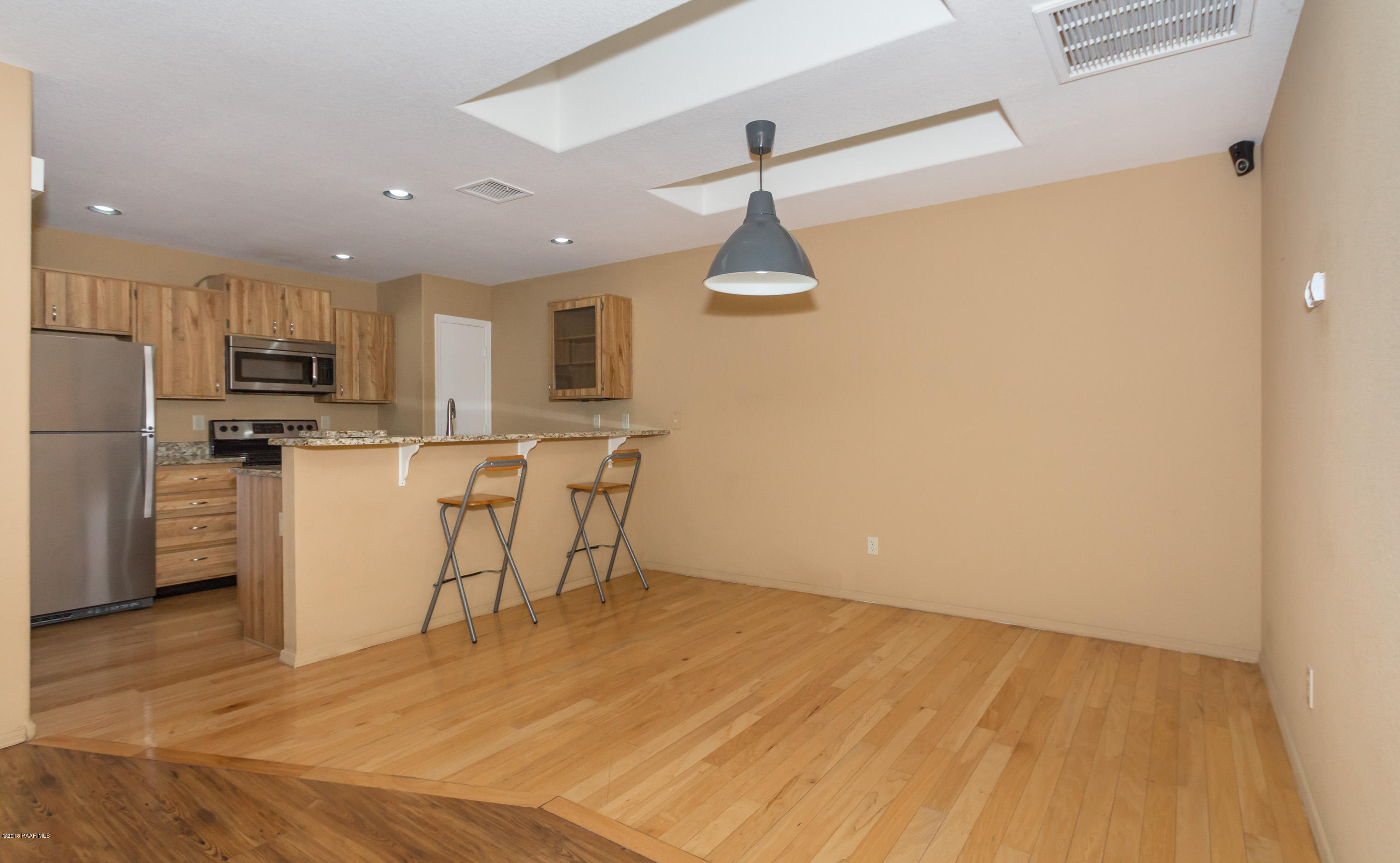 3059 Smokey Road, Unit 21B Prescott, AZ 86301 - Photo 6 of 21 a view of a kitchen with wooden floor and electronic appliances
