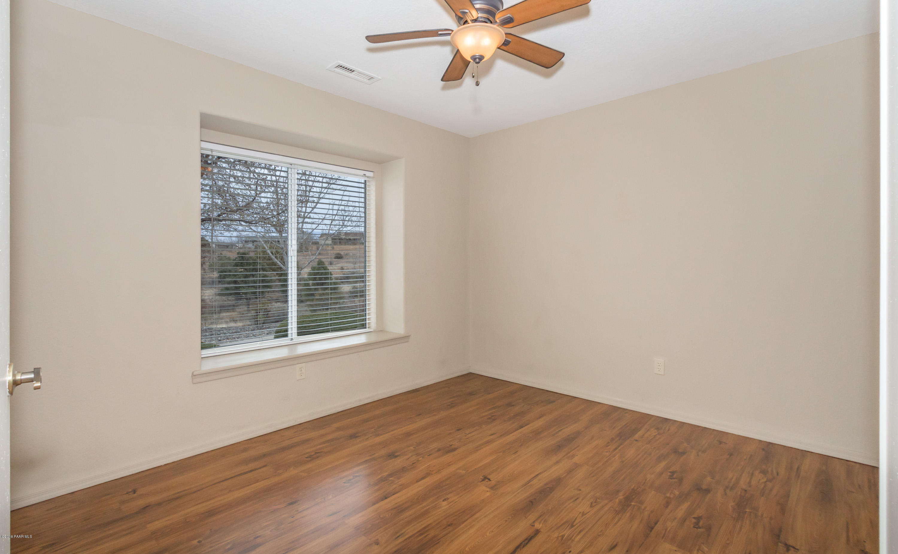 3059 Smokey Road, Unit 21B Prescott, AZ 86301 - Photo 7 of 21 an empty room with wooden floor fan and windows