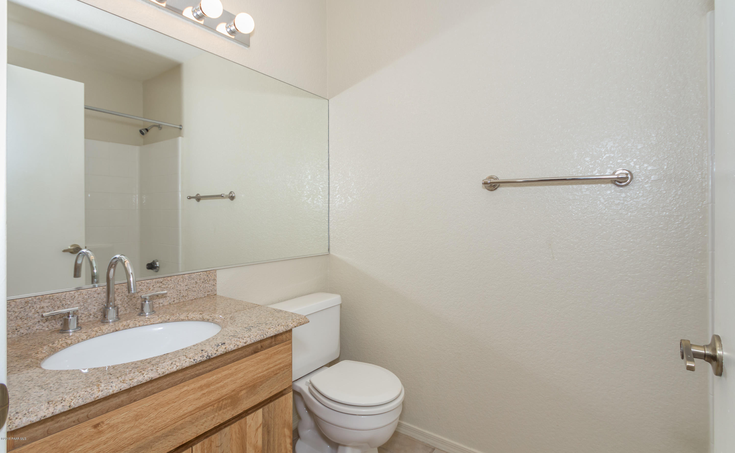3059 Smokey Road, Unit 21B Prescott, AZ 86301 - Photo 9 of 21 a bathroom with a granite countertop sink a toilet and a mirror